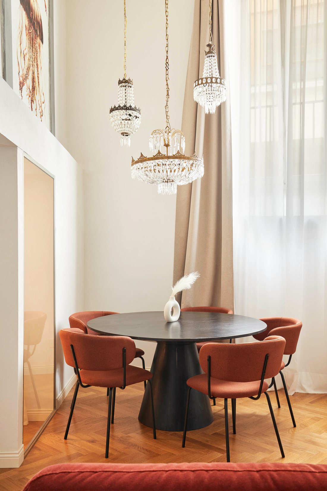 Sala da pranzo con tavolo tondo e lampadari di cristallo